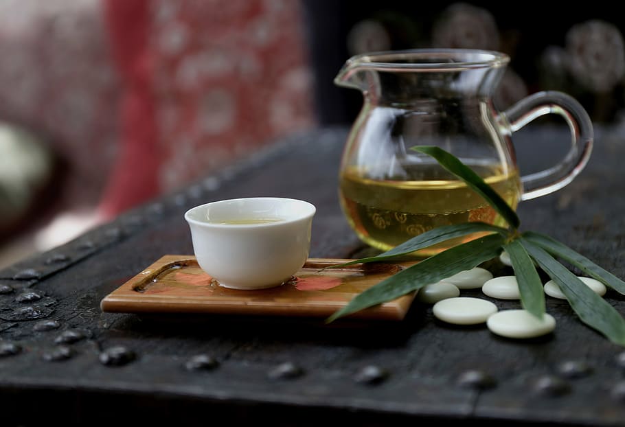 clear glass teapot and white ceramic teacup on black table HD wallpaper