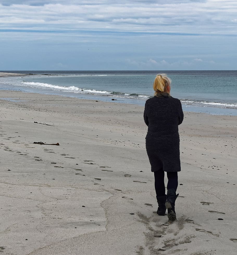 woman walking at seashore under white clouds, beach, alone, sand