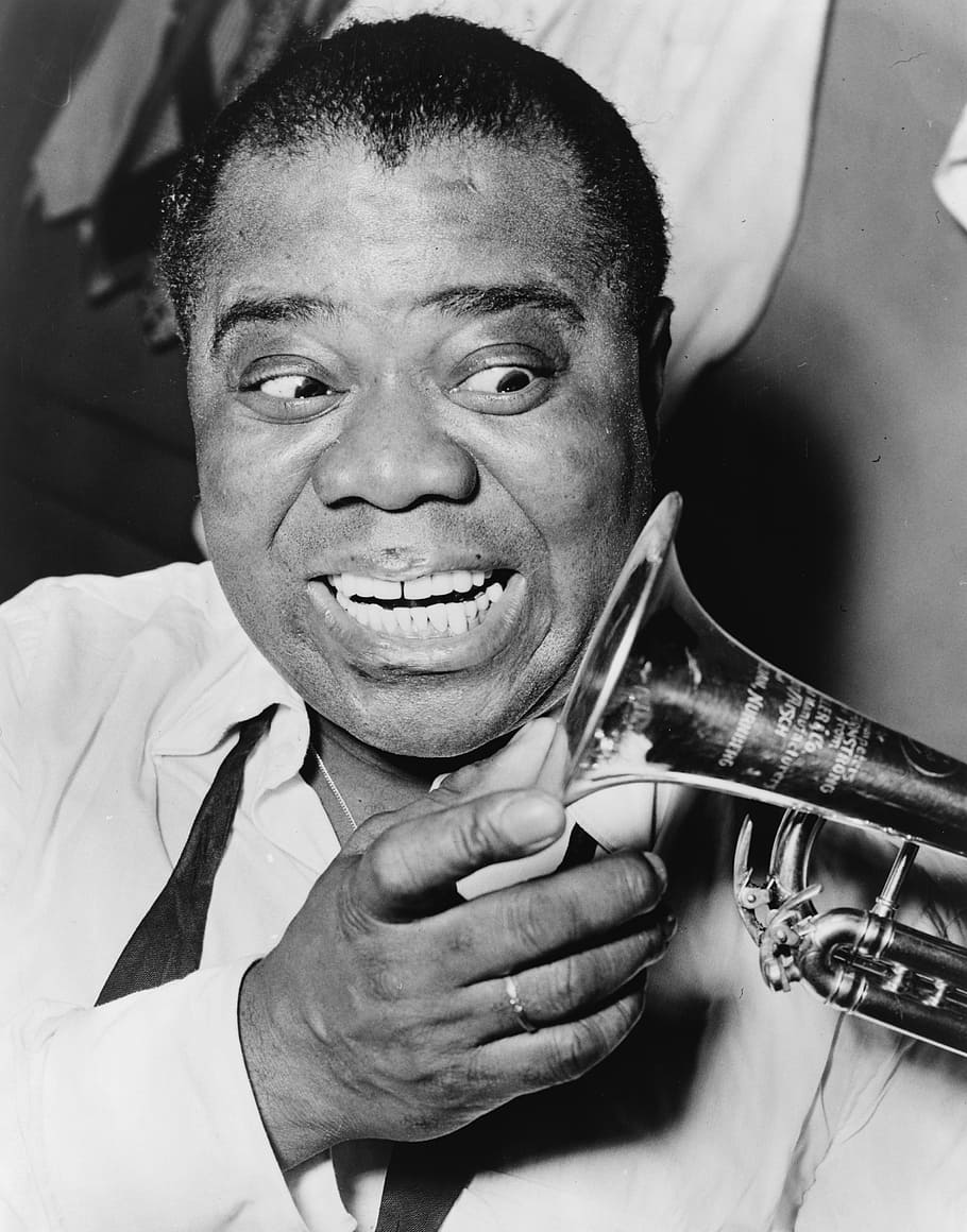 grayscale photography of man holding wind instrument, louis armstrong