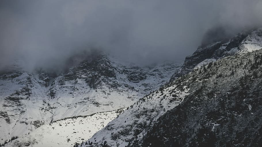 aerial photography of fog covering mountain top, gray rock mountain covered with clouds HD wallpaper