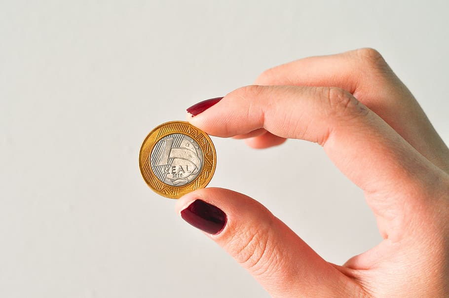 person holding round silver-and-gold-colored coin, Money, Currency