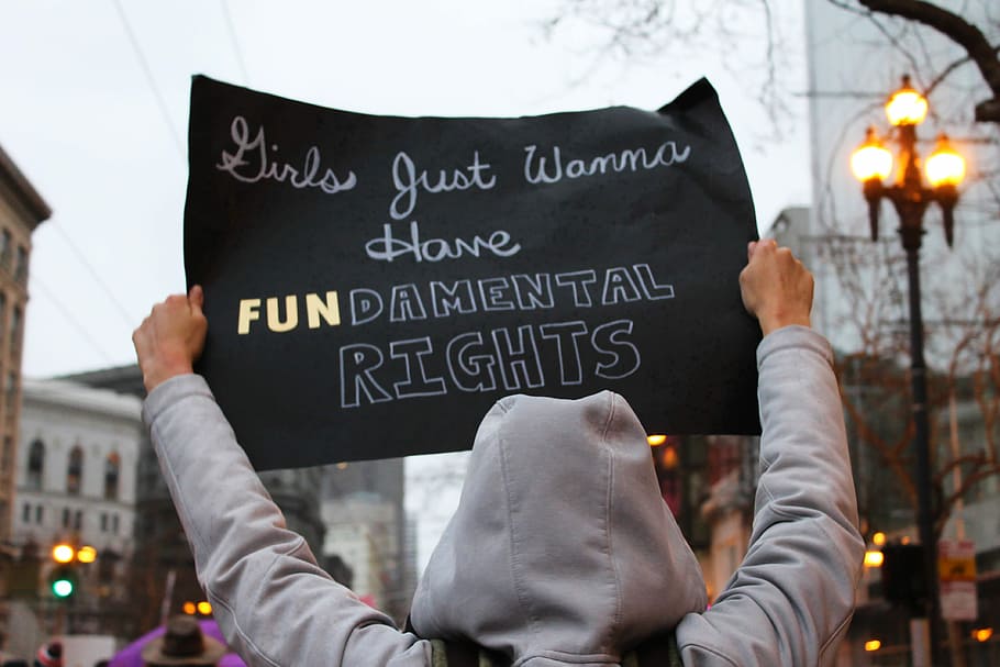 person in gray hooded jacket holding black sign, women's hooded jacket HD wallpaper