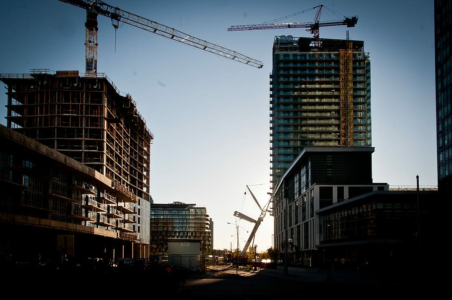 building construction with cranes, two black tower cranes on buildings HD wallpaper