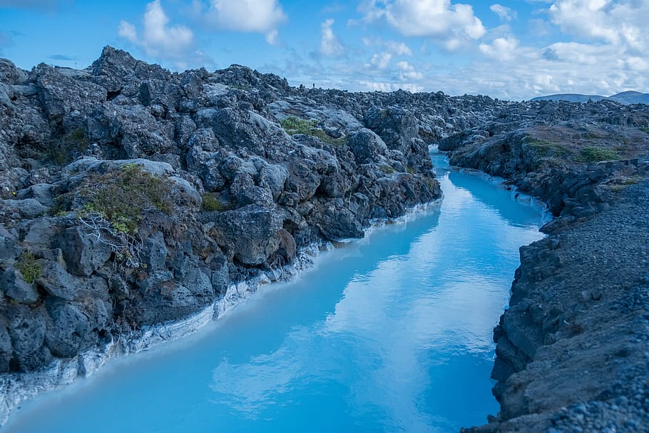 landscape photo of rock formation near body of river, body of water surrounded by rock formation HD wallpaper