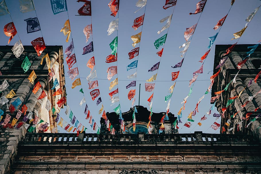 low angle photo of temple, assorted-color buntings on building HD wallpaper