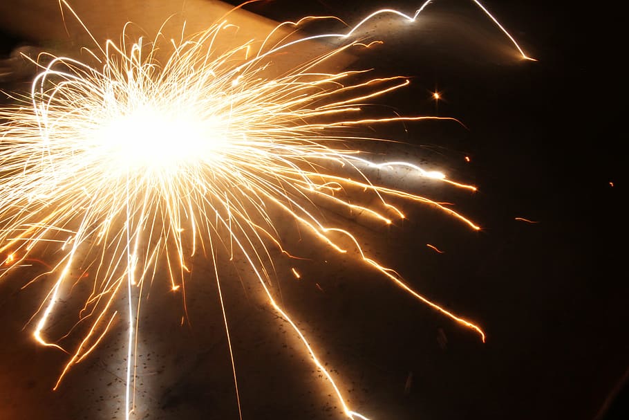 flame sparks on black metal board, fireworks, explosion, holiday