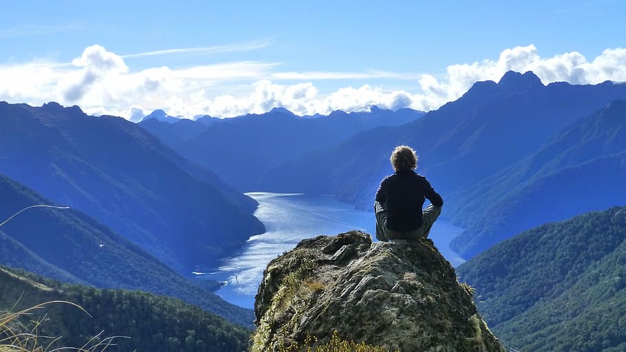 person sitting on top of a mountain during daytime, kepler track