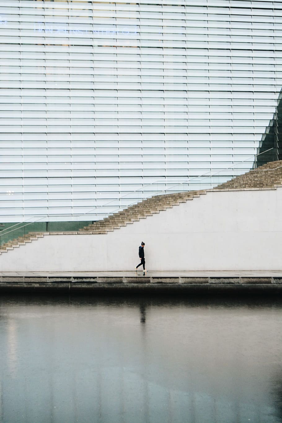 person walking beside concrete staircase, man walking along the street HD wallpaper