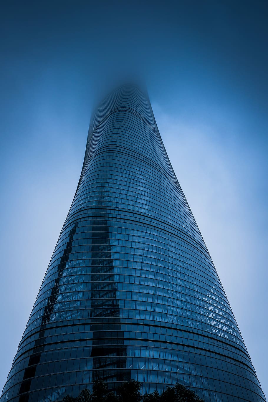 low angle photography of gray curtain wall building covered with fog, low-angle photography of twisted glass high-rise building HD wallpaper