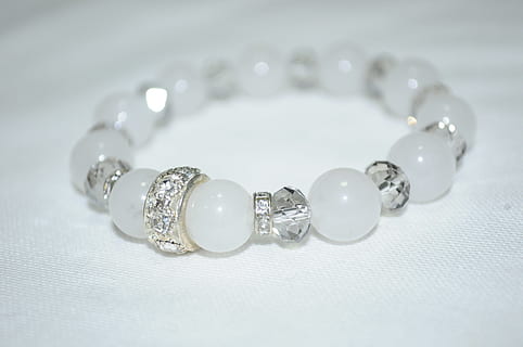 beaded white and silver-colored bracelet on white textile, accessory HD wallpaper