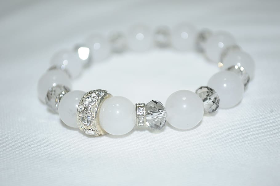 beaded white and silver-colored bracelet on white textile, accessory HD wallpaper