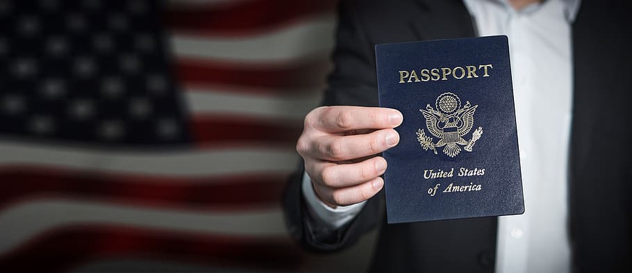 person holding passport of United States of America, id, entry