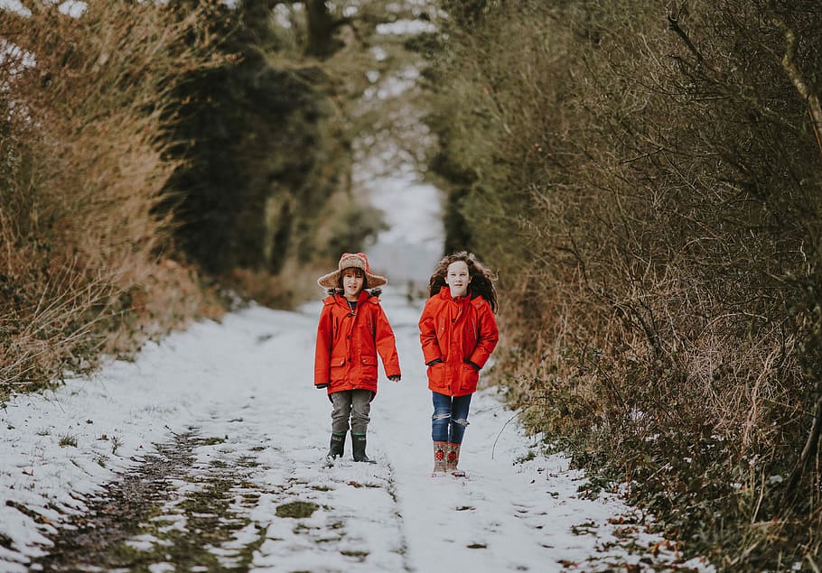 Children walking in the snow, boy in red coat standing on road during daytime HD wallpaper