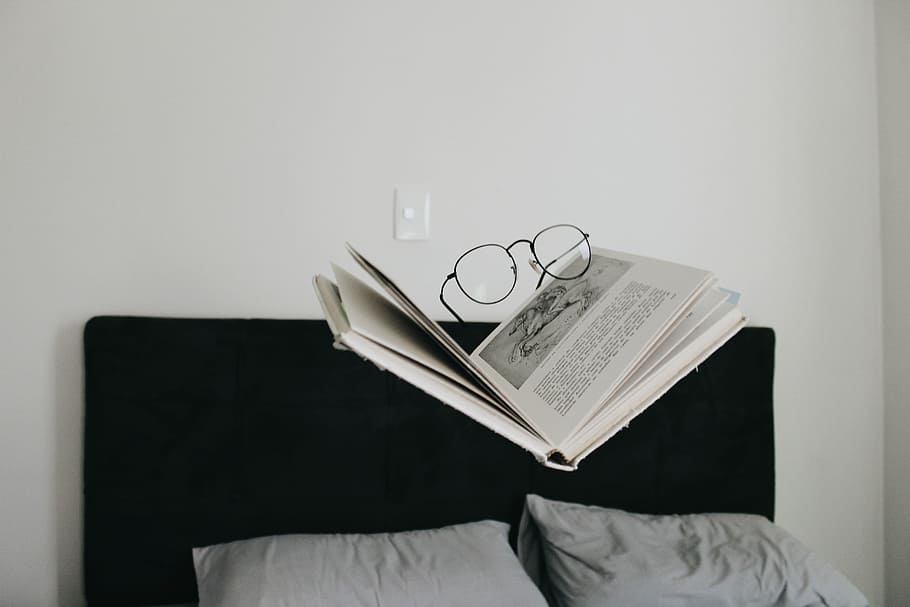 eyeglasses on top of book above bed, eyeglasses on top of hardbound book HD wallpaper