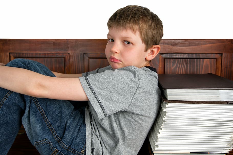 boy wearing gray crew-neck t-shirt leaning book lot, sad, learning HD wallpaper