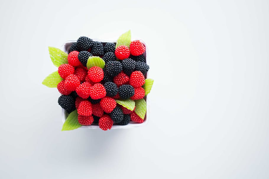 bowl of red and black berries, flat lay photography of raspberries HD wallpaper