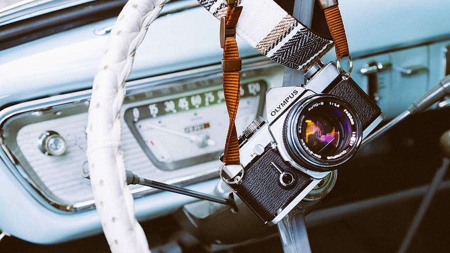 silver and black Olympus camera hanging, black and gray Olympus camera closeup photography HD wallpaper