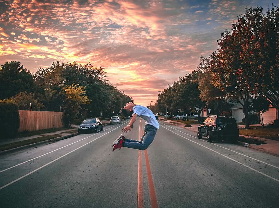 man jumping on road during golden hour, man jumping on center road HD wallpaper