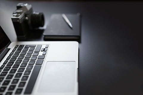 MacBook Pro beside camera, notebook and pen, black, grey, laptop HD wallpaper