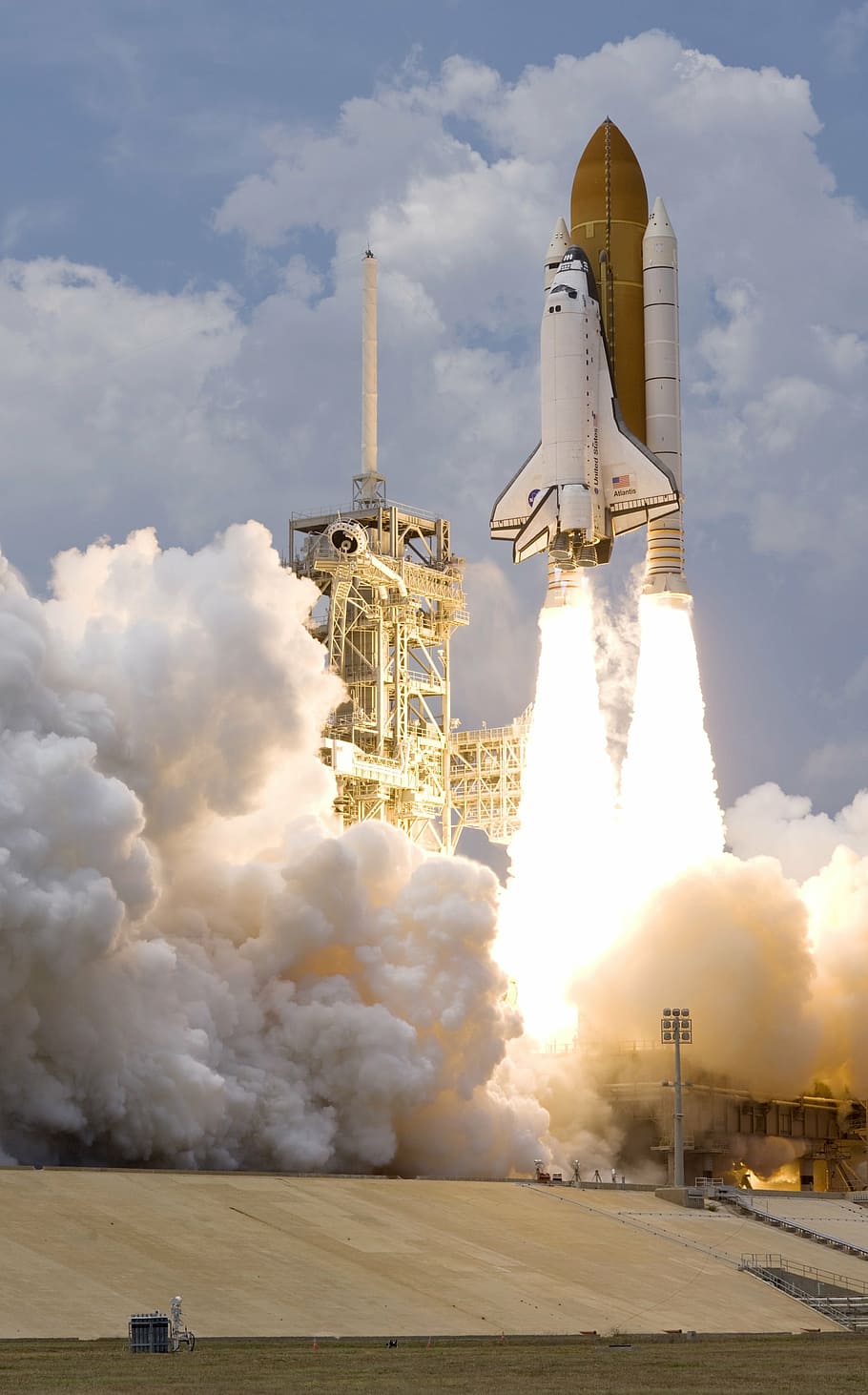 blue and white rocket blasting off during daytime, space shuttle