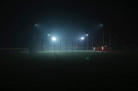 Football field with four lights on the court, night, stadium HD wallpaper