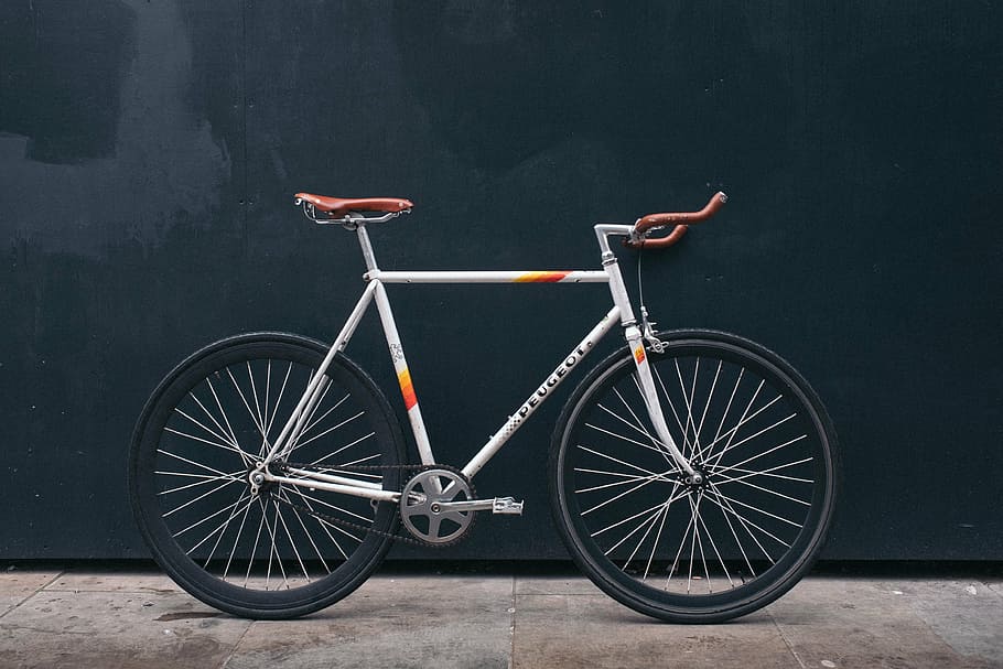 gray and orange road bike parked on black wall, bicycle, wheels HD wallpaper