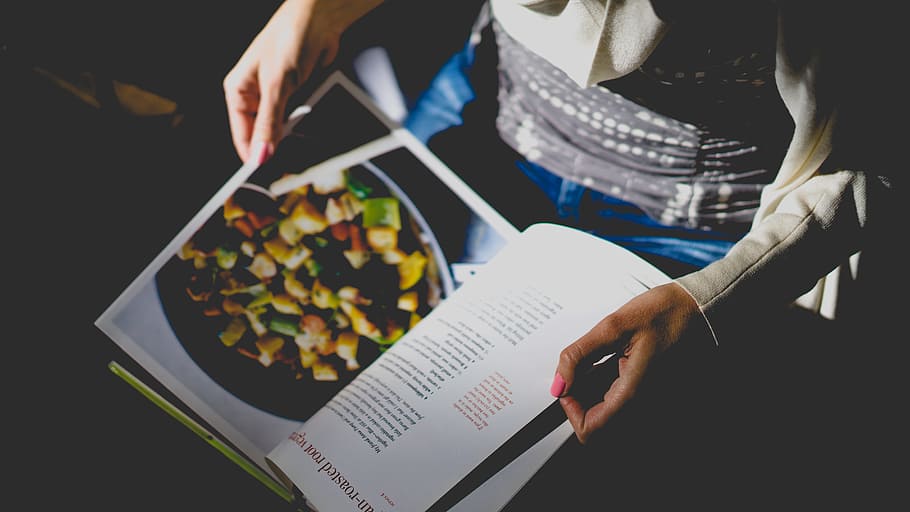person looking at magazine, person reading cookbook, food, people HD wallpaper