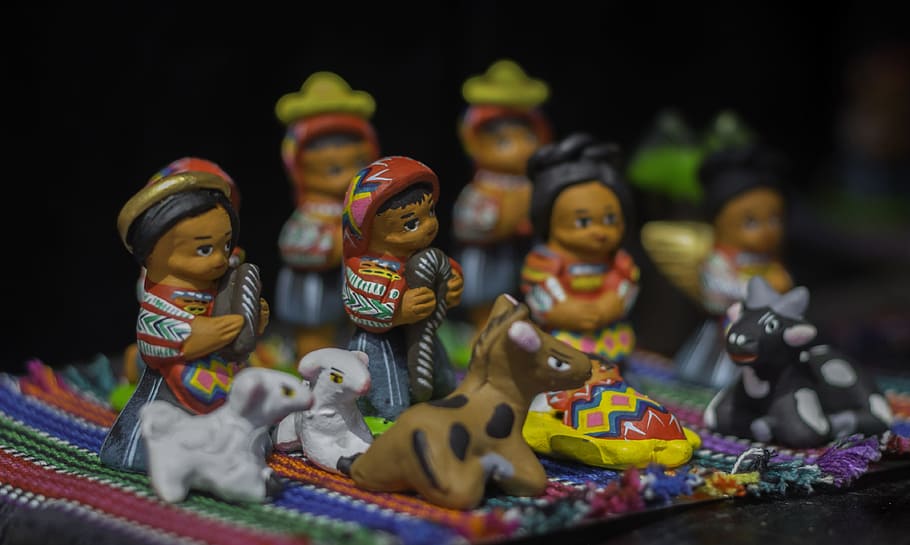 ceramic figurines on orange textile, Guatemala, Culture, Crafts