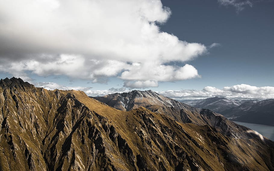 brown mountain ranges under white clouds, rocky mountain under cloudy sky HD wallpaper