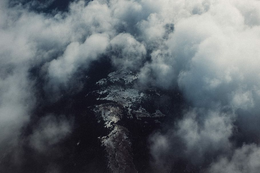cumulus clouds over body of water, brown rocky mountains under white clouds HD wallpaper