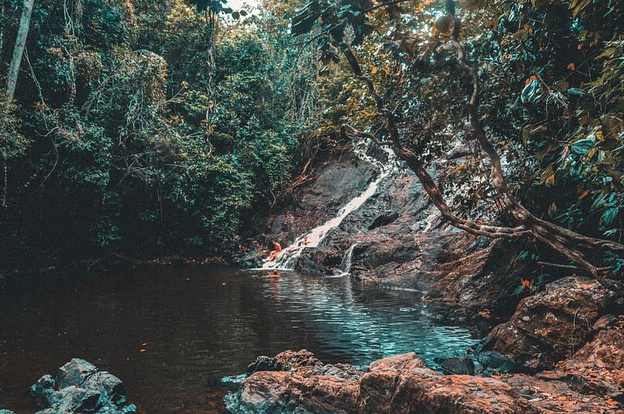person sitting on rock waterfalls, time lapse photo of flowing body of water during daytime HD wallpaper