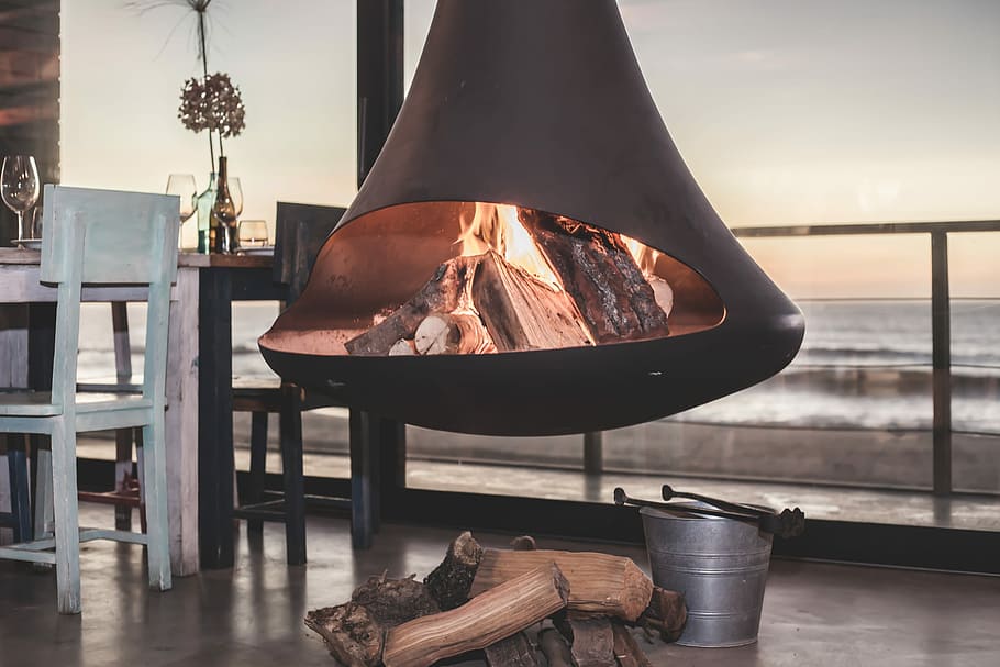 black firepit near dining set inside room, firewoods in black firepit HD wallpaper