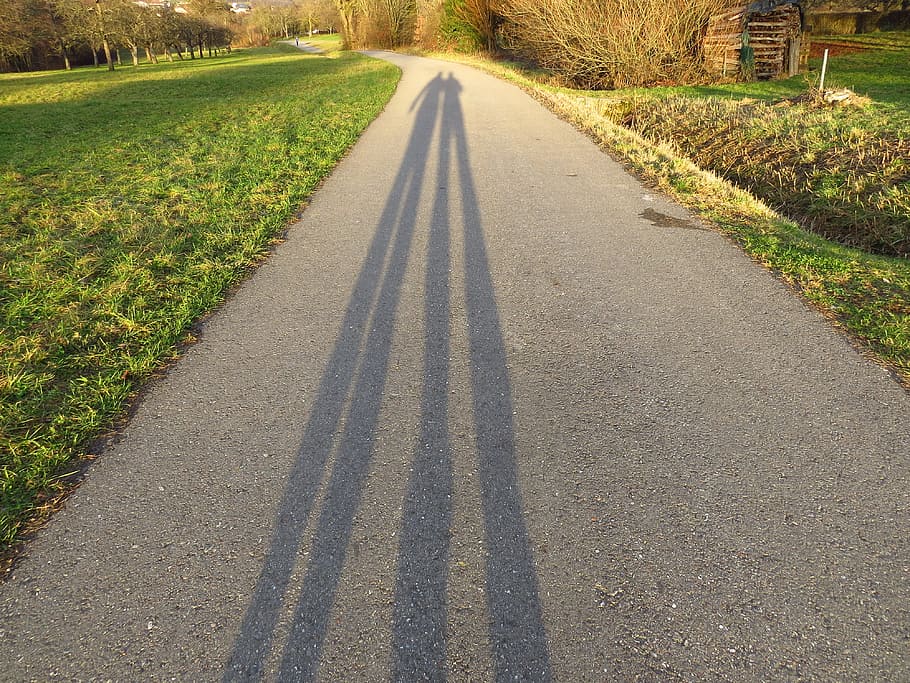 two person's shadow on street between green grass, away, personal HD wallpaper