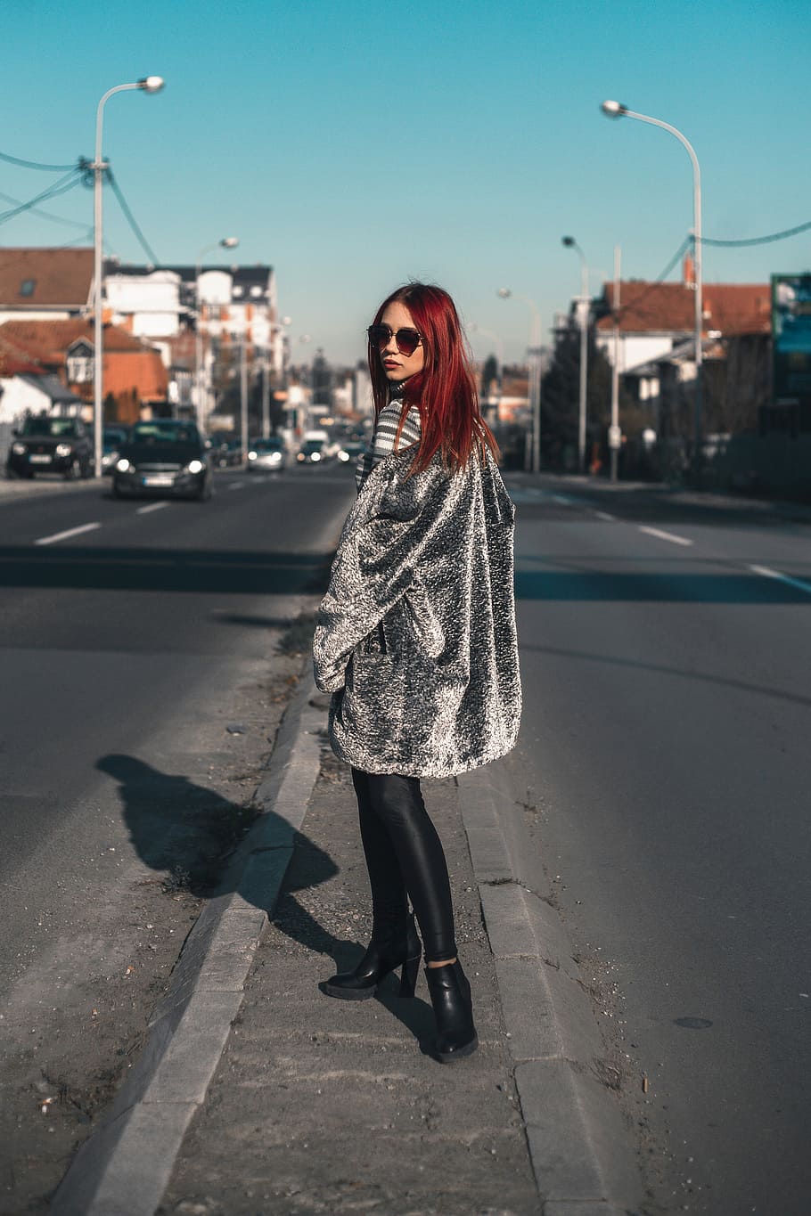 Fashion redhead girl walking down the street, woman walking on stree