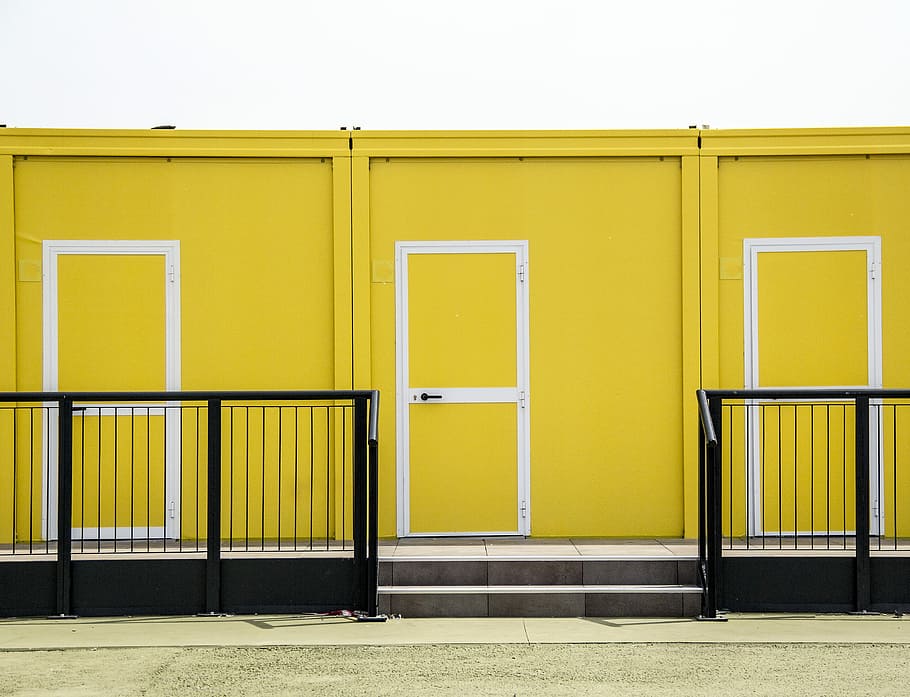 yellow and white painted wall, yellow and white doors near black metal hand rails HD wallpaper