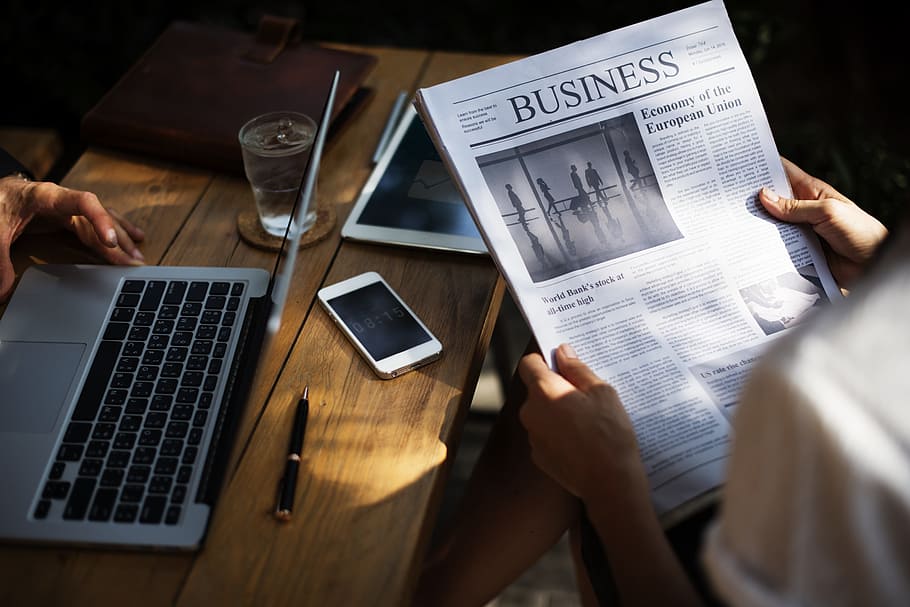 person holding Business newspaper, cup, drinks, coffee shop, online