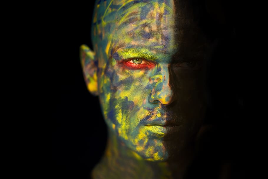 man's face full of paints, fiction, make-up, green, red, camouflage