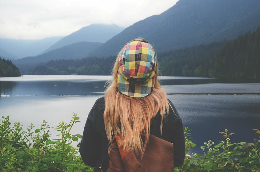 photo of person wearing brown leather knapsack, lake, mountain range HD wallpaper