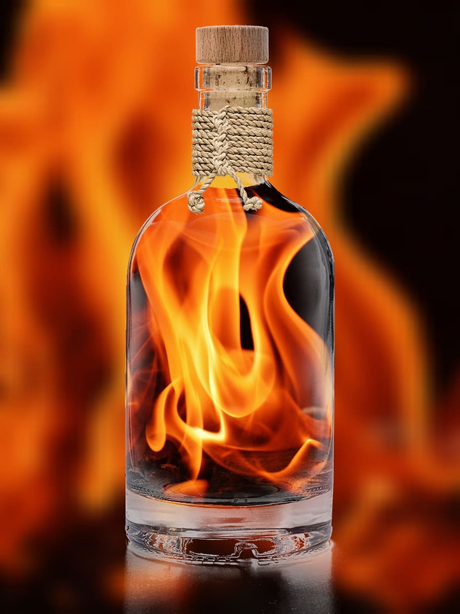 clear glass bottle with fire in side photo, flame, embers, bottle fiery