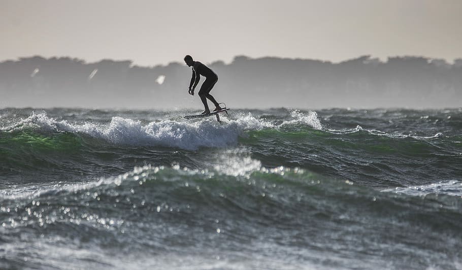 time lapse photography of man riding surfboard, silhouette photo of surfing man HD wallpaper