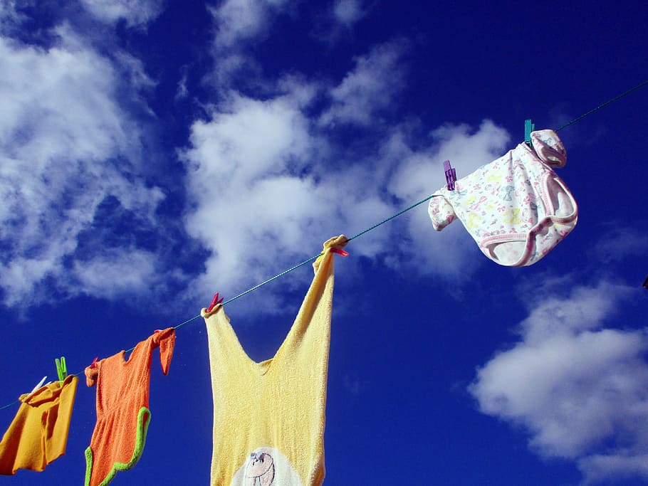 four assorted-color clothes hanging on rope, clothes line, wash clothes