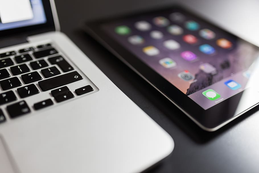 black iPad beside MacBook, laptop, computer, tablet, technology HD wallpaper