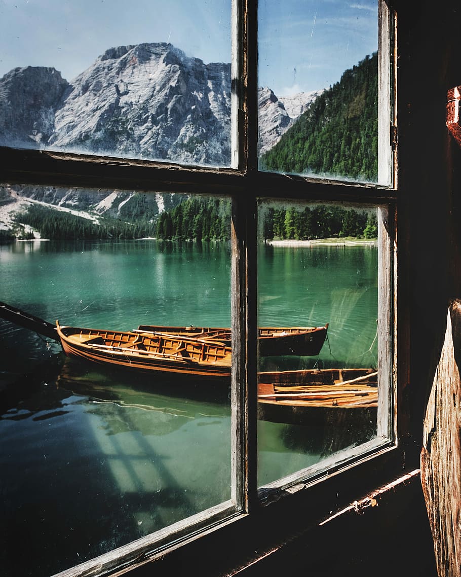 four brown wooden boat near dock, photography of brown wooden kayaks docked beside wooden house at daytime HD wallpaper