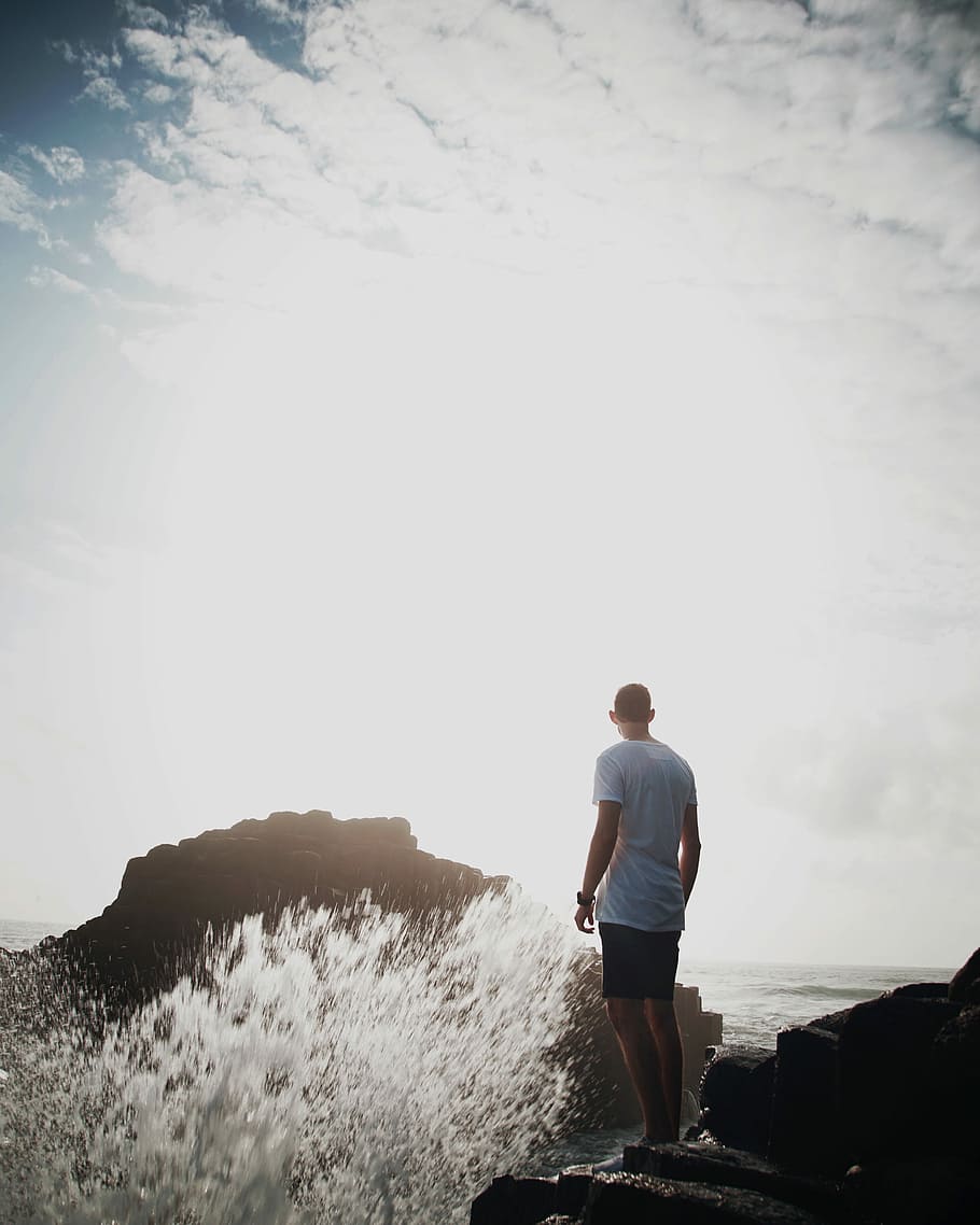 man wearing white shirt near rock formations, nature, beach HD wallpaper