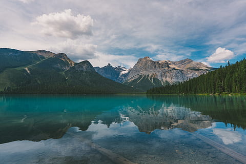 body of water across mountains, body of water surrounded by trees near mountain range HD wallpaper