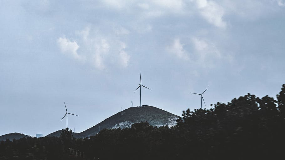 silhouette of trees near windmill under gray sky, windmill on mountain HD wallpaper
