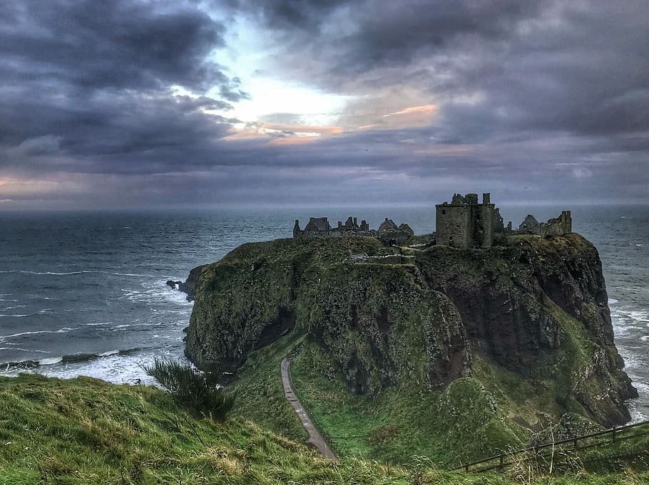 Scottish Castle, green grass covered mountain near sea, rock HD wallpaper