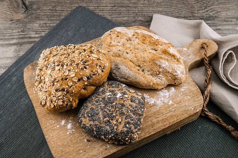 three toasted bread on brown chopping board, three pastries, food HD wallpaper