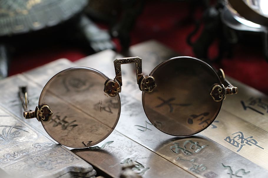 selective focus photo of round brown lens sunglasses with gold frames on kanji tiles HD wallpaper