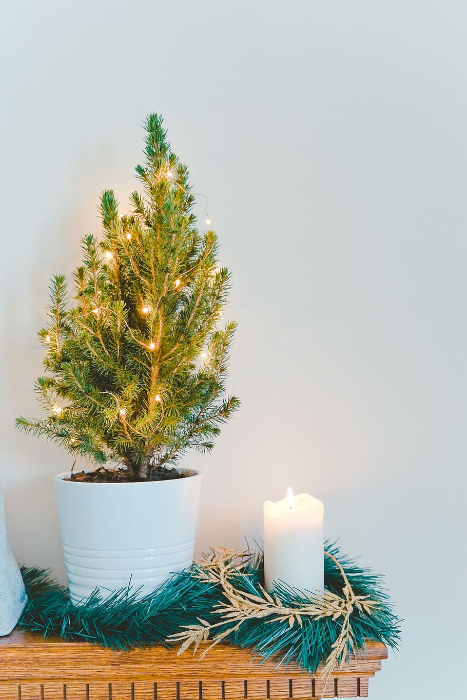 white pillar candle, kindled pillar candle, tree, lights, foliage HD wallpaper